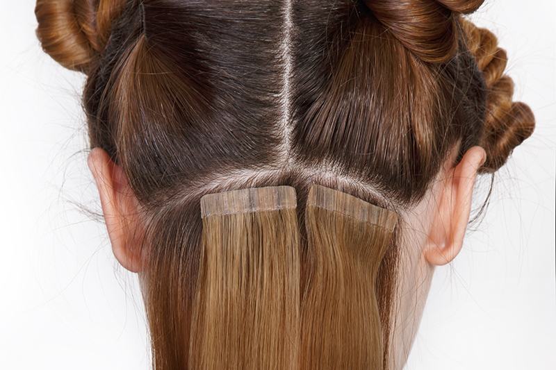 Hair extension with tapes